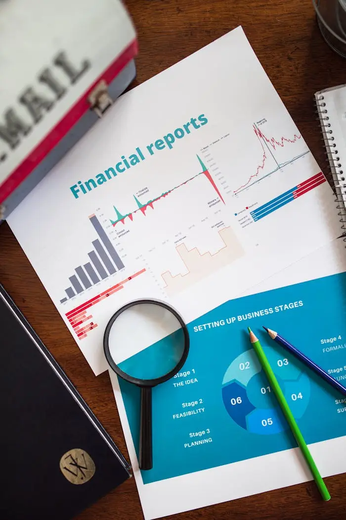 Financial report with charts and graphs analyzed with a magnifying glass.